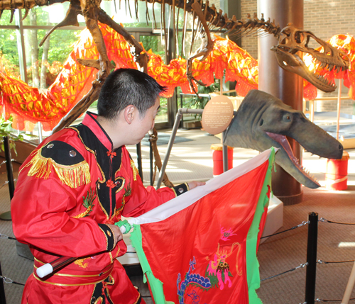 Dragon Dancer Johnny Wu with dinosaurs