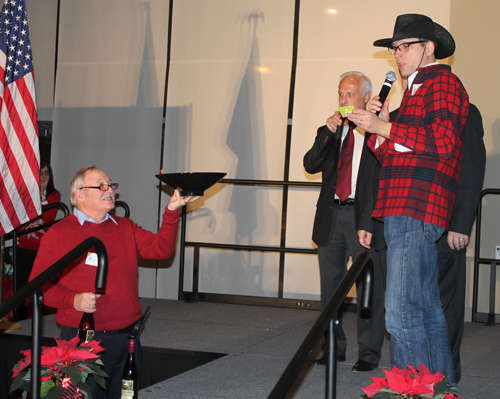 Cleveland Councilman Brian Cummins pulls a winning raffle ticket from ICC-WIN board member George Burke