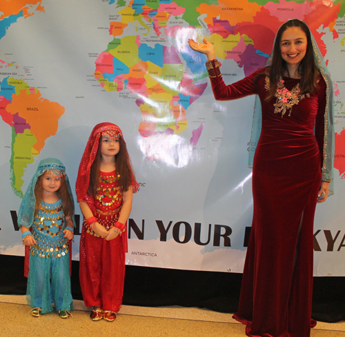 Mother Tugce Sareyyuoglu and young daughters Ceren and Defne Posing with a map of Turkey