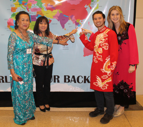 Gia Hoa Ryan, Oahn Loi-Powell, Evan Powell and Madi Harris Posing with a map of Vietnam