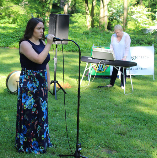 singing of the national anthem by a student from Olga's Music Studio