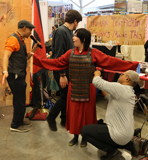 Trying on armor at Silk Road Cultural Collective at 2026 Cleveland Fan Expo