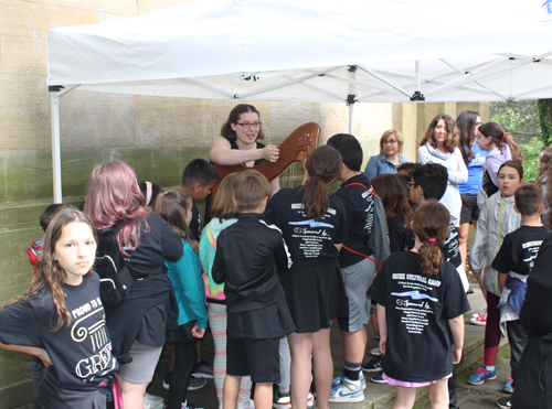 Harpist Gabrielle Fitzpatrick demonstrated her harp and let the kids pluck or strum the strings