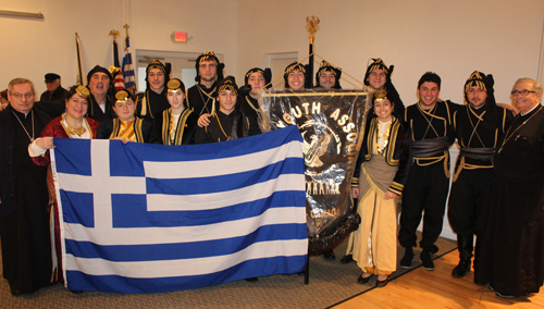 Youth with priest and Greek flag