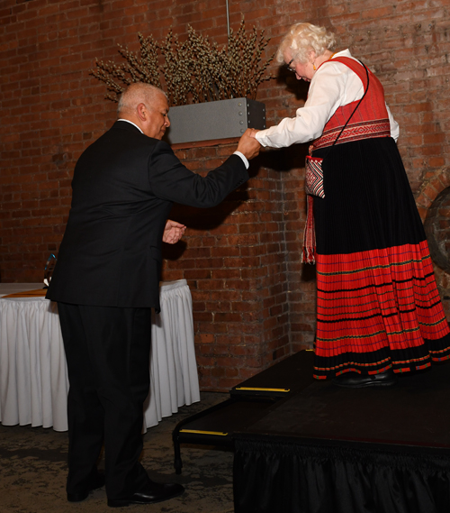 MC Russ Mitchell helps Erika Puussaar off the stage