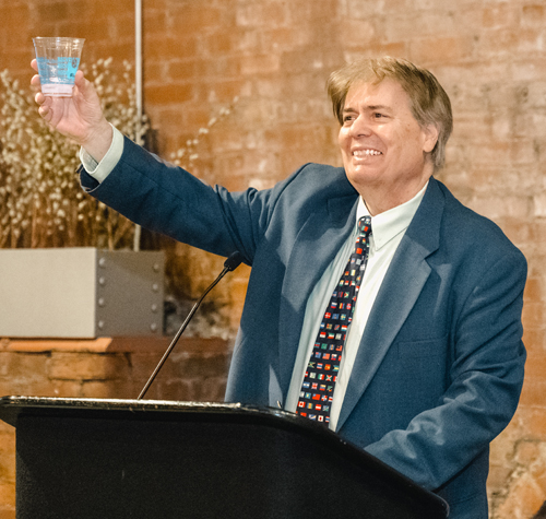 Dan Hanson leads the customary toast to the 6 new inductees
