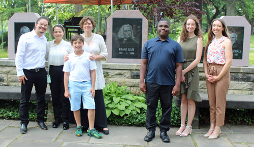 Vera Holzer and students in front of Bartok, Liszt and Kodaly