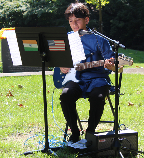 Young Indian boy performing on guitar