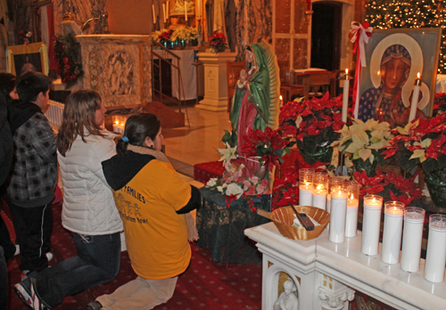 Praying in front of icon of Our Lady of Czestochowa