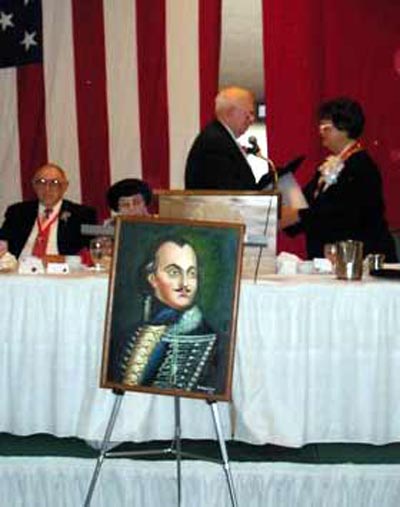 Mercedes Karpinski Spotts receiving award with Pulaski painting in front