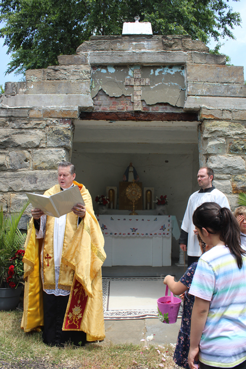 Father Eric prays at Corpus Christi procession at St Casimir Church in Cleveland