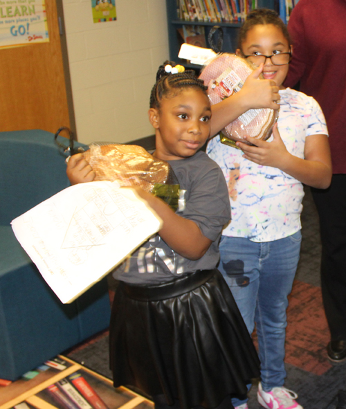 Kids with donated hams at Willson School