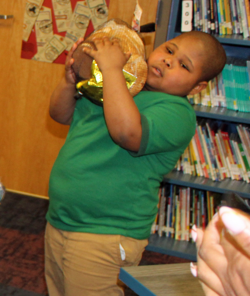 Young boy with donated hams at Willson School