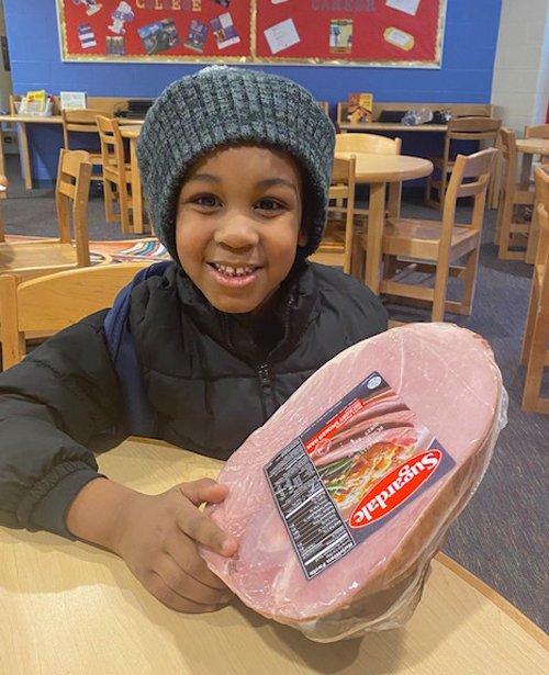 Youngster with ham from St. Casimir Hams for Fams