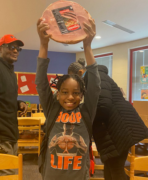 Youngster with ham from St. Casimir Hams for Fams