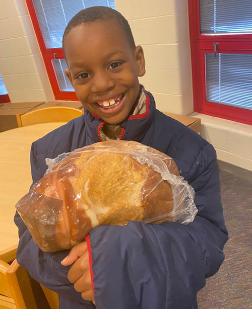 Youngster with ham from St. Casimir Hams for Fams