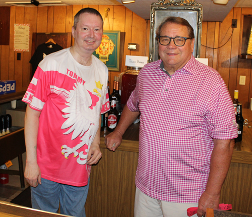 Gary Adams (right) tending bar