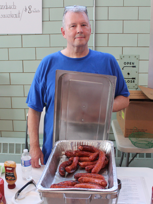 Volunteer serving Polish food at Taste of St Casimir