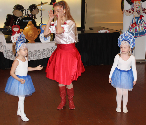 Alena Reshetnikova from the Paprika Dance Ensemble with two young girls