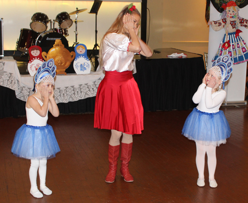 Alena Reshetnikova from the Paprika Dance Ensemble with two young girls