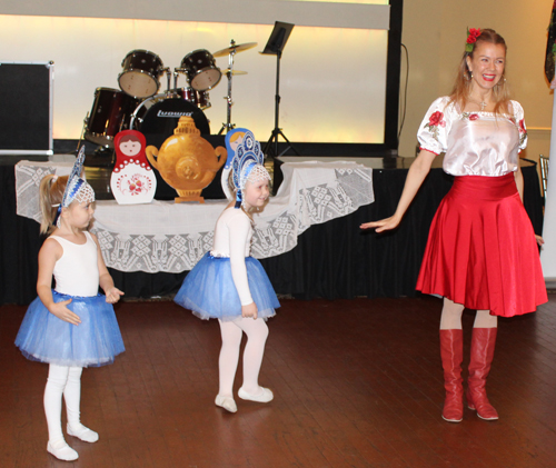 Alena Reshetnikova from the Paprika Dance Ensemble with two young girls