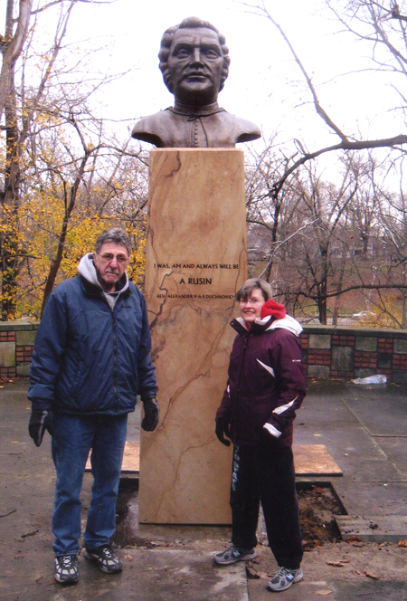 John Krenisky and Marcia Benko from the Carpatho-Rusyn Society at bust of Dukhnovych in Carpatho Rusin Garden in Cleveland Ohio