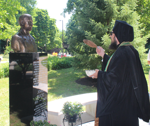 Fr. Neftaria blesses the bust of Jovan Ducic