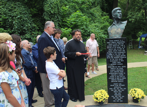 Father Kosic at Djokovic bust