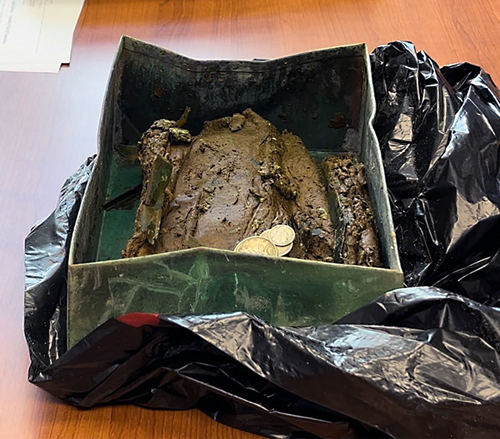 Contents of the church cornerstone suffered severe water damage due to the cornerstone's position in the church wall.