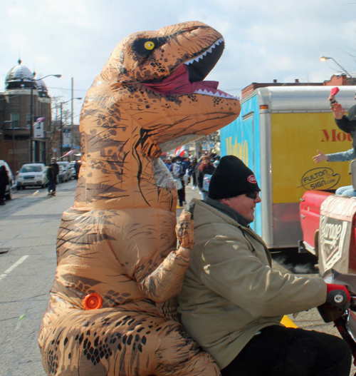 Dinosaur on bike at 2022 Kurentovanje Parade in Cleveland