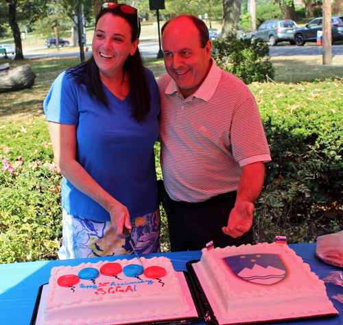 Julie Tromba and Bob Hopkins cut the Slovenian anniversary cake