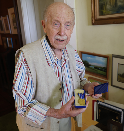 August Pust with one of his medals