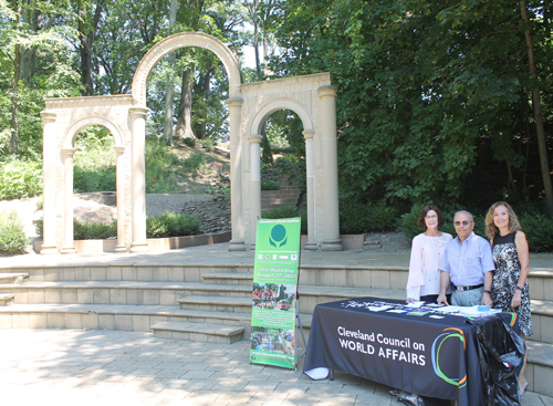 Maura O'Donnell-McCarthy, Wael Khoury,M.D. and Sawssan Khoury at the CCWA table in front of the Arch of Palmyra in the Syrian Cultural Garden at the Common Ground event