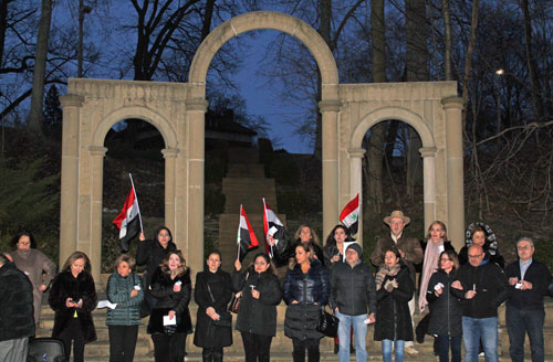 Syrian flags in front of Arch of Palmyra