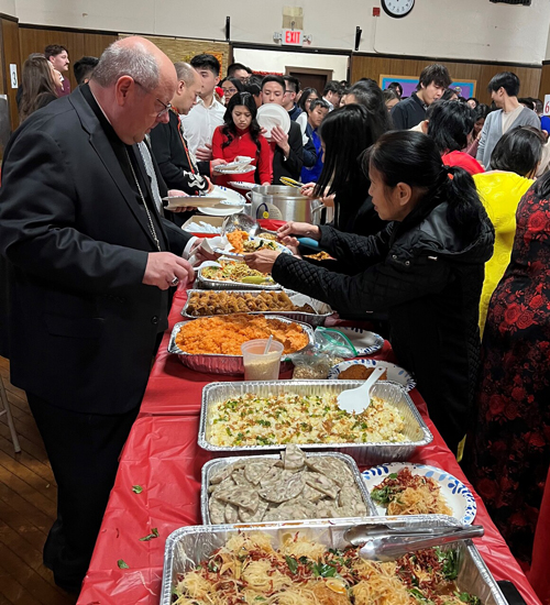 Bishop Malesic with Vietnamese food